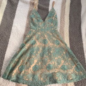 Nude dress with blue lace appliqués